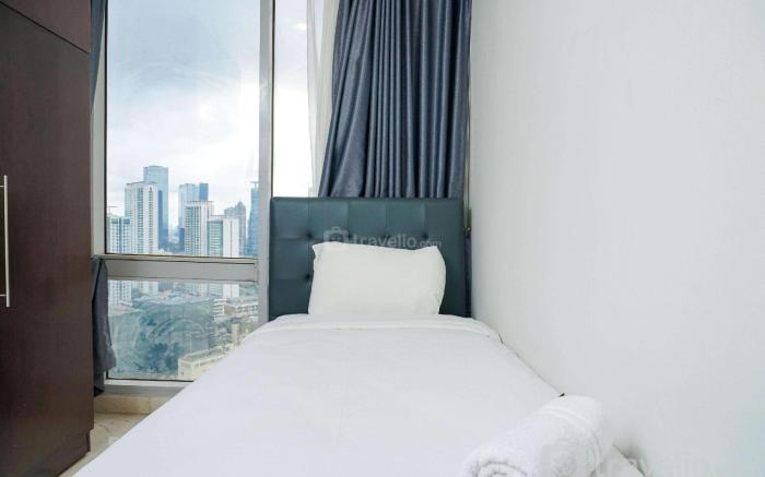 Cozy 2BR Empyreal Epicentrum Apartment By Travelio