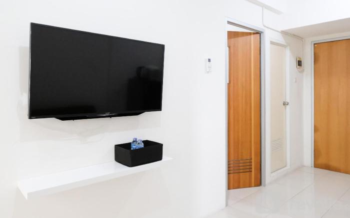 Homey 2BR at Puncak Permai Apartment By Travelio