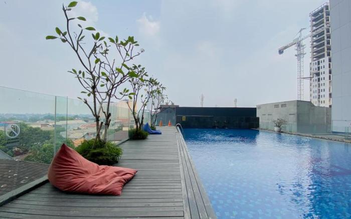 Wooden Nest 2BR Evenciio Margonda Apt By Travelio