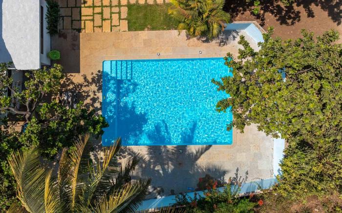 StayVista's Santoni Farms - Riverside Bliss with Pool, Orchard & Activities
