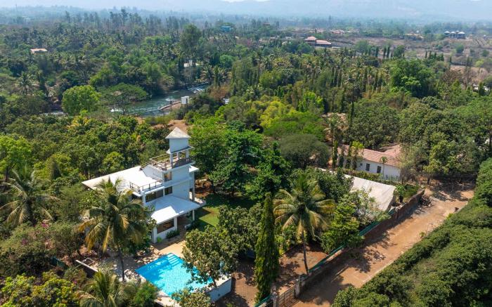 StayVista's Santoni Farms - Riverside Bliss with Pool, Orchard & Activities