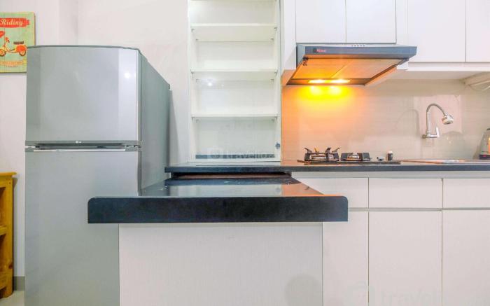 Furnished Green Pramuka 1BR Apartment By Travelio