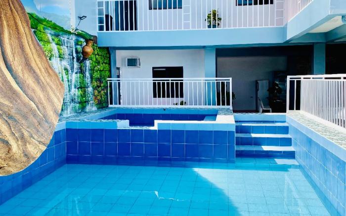 Refreshing 4 bedroom home with a waterfall pools