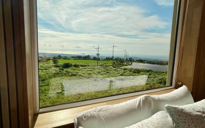 C#1 West Sunset View Full Window Distant Sea View Rattan Wood Room