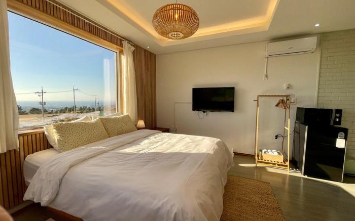 C#1 West Sunset View Full Window Distant Sea View Rattan Wood Room
